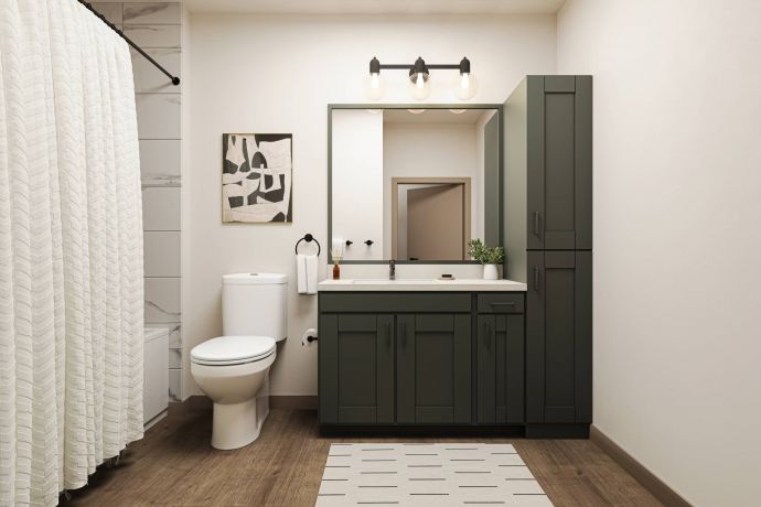 Allers Landing Modern bathroom with dark green vanity, white toilet, wall art, shower curtain, and striped rug on wood floor.